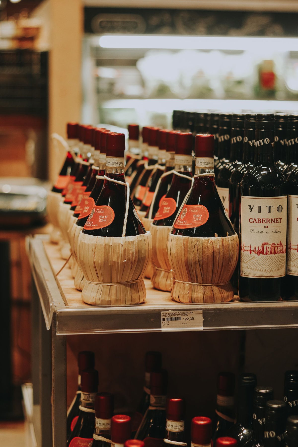 Rows of assorted wine bottles displayed on a store shelf