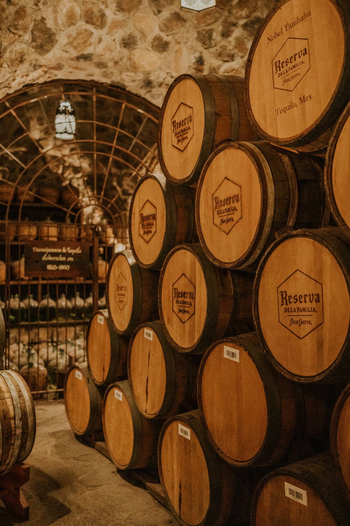 Oak barrels stacked in a tequila aging cellar in Jalisco, Mexico
