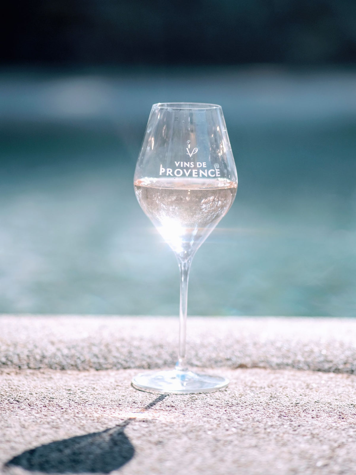 A glass of pale Provence rose on a sunlit terrace