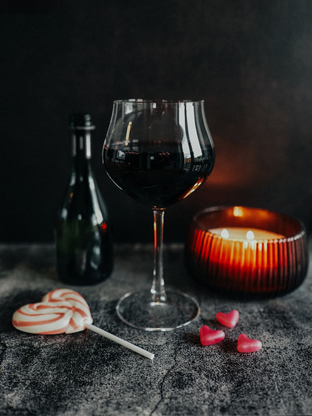 Elegant glass of sweet white wine by candlelight with desserts