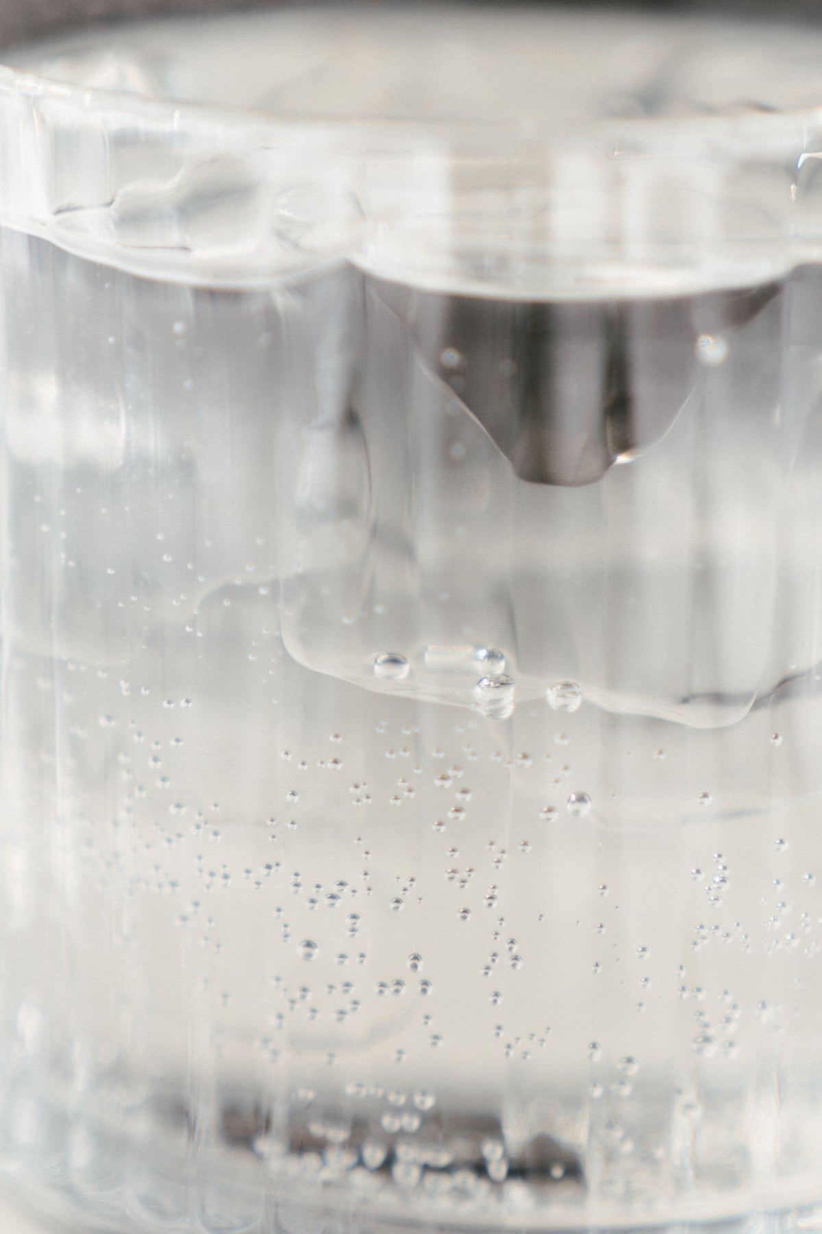 Clear vodka cocktail with bubbles in a glass