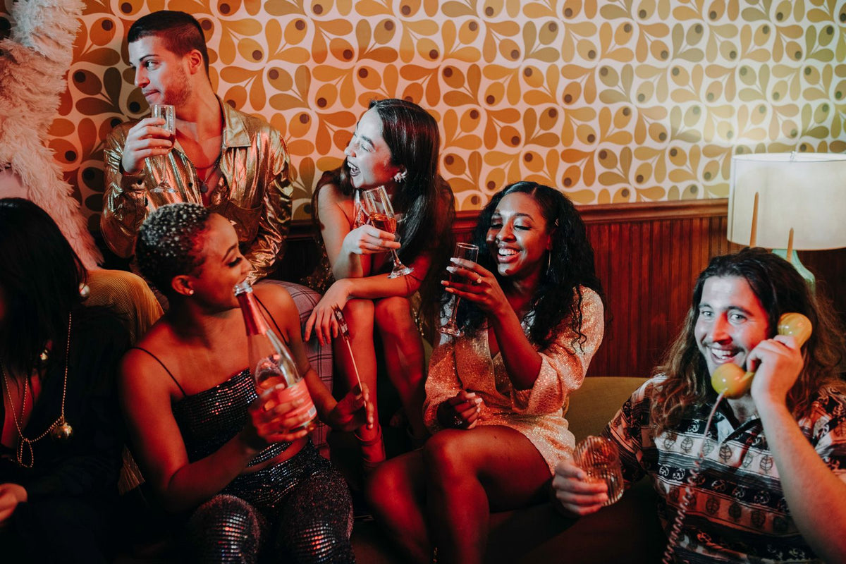 Friends raising sparkling wine glasses together at a festive celebration