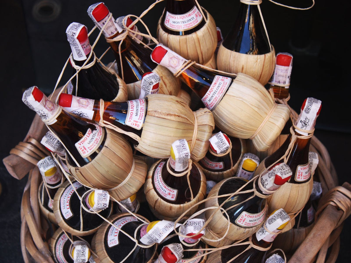 Chianti wine bottles in traditional straw baskets