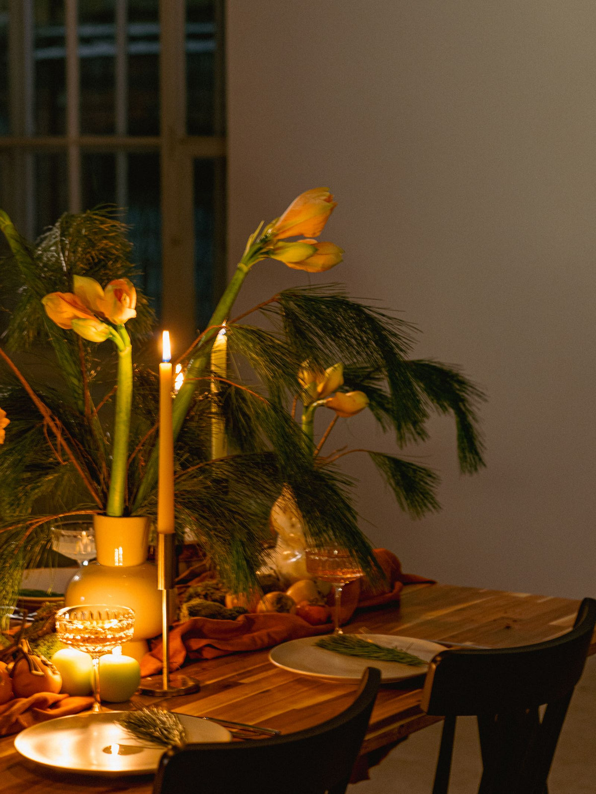 A softly candlelit table set for an evening gathering