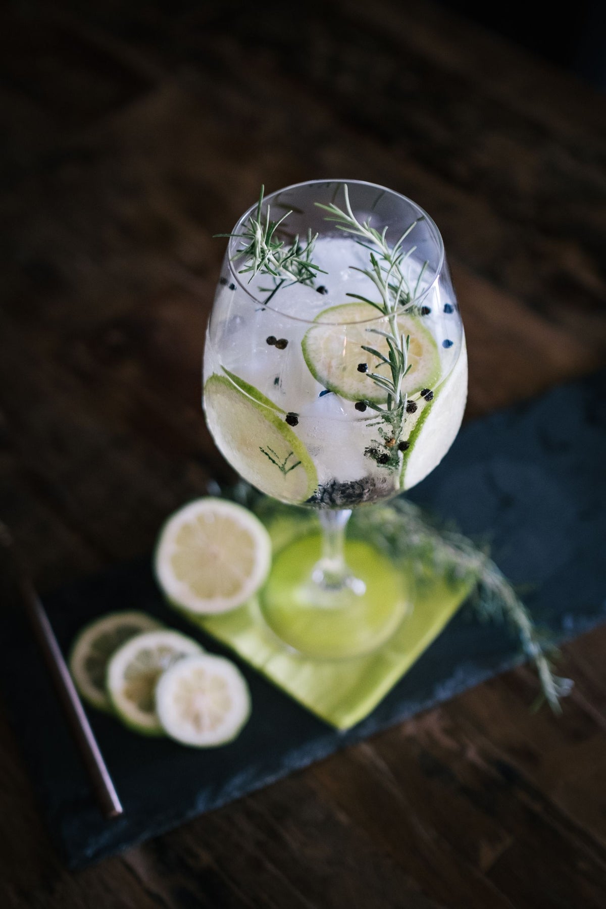 Gin and tonic garnished with lemon and rosemary