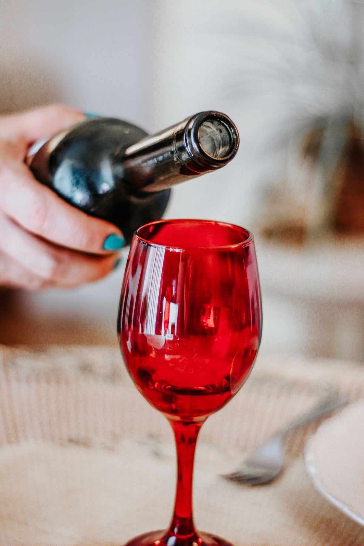 Close-up of red wine being poured into a wineglass