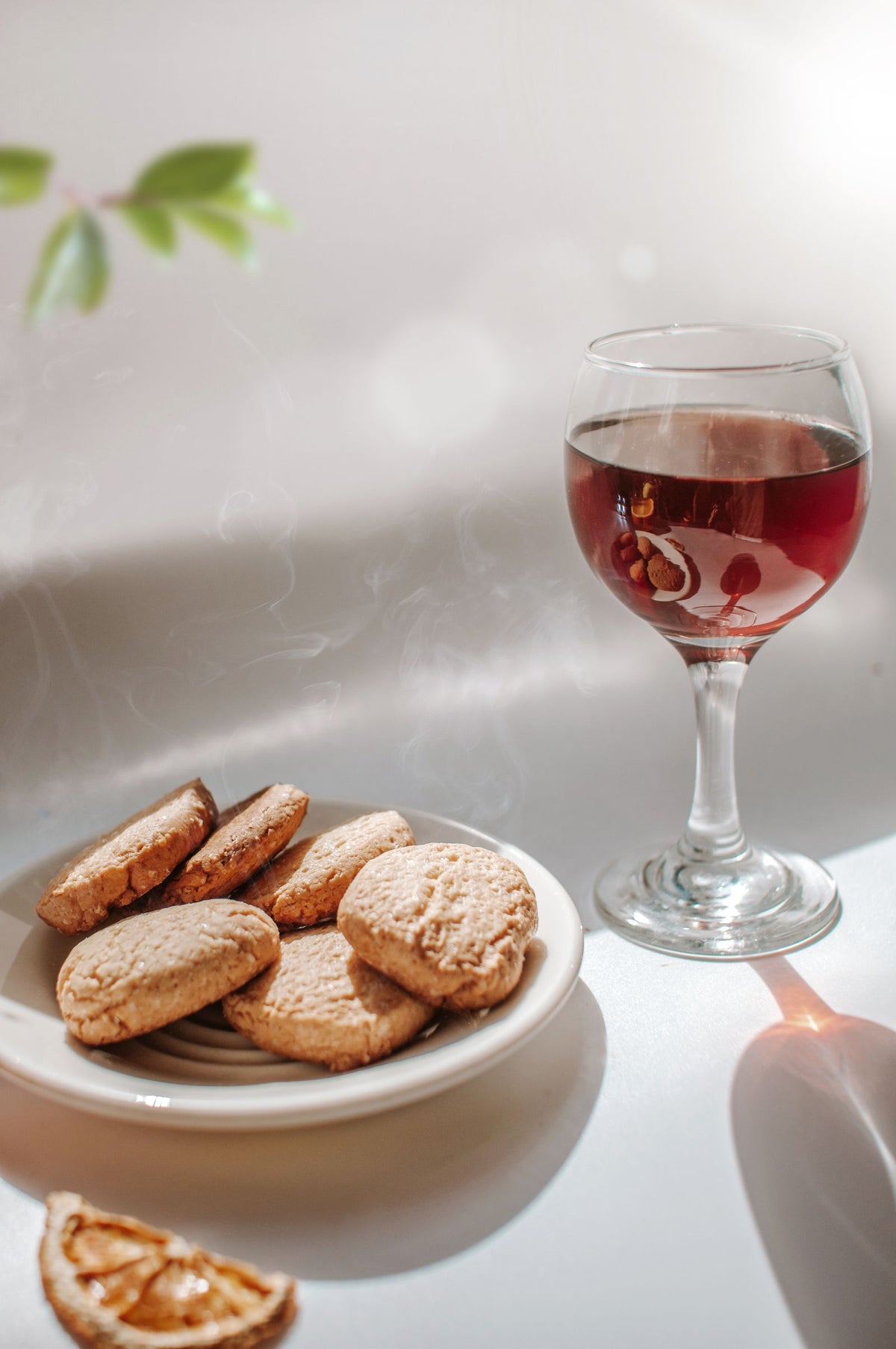 Glass of sweet Moscato wine with cookies in warm natural light