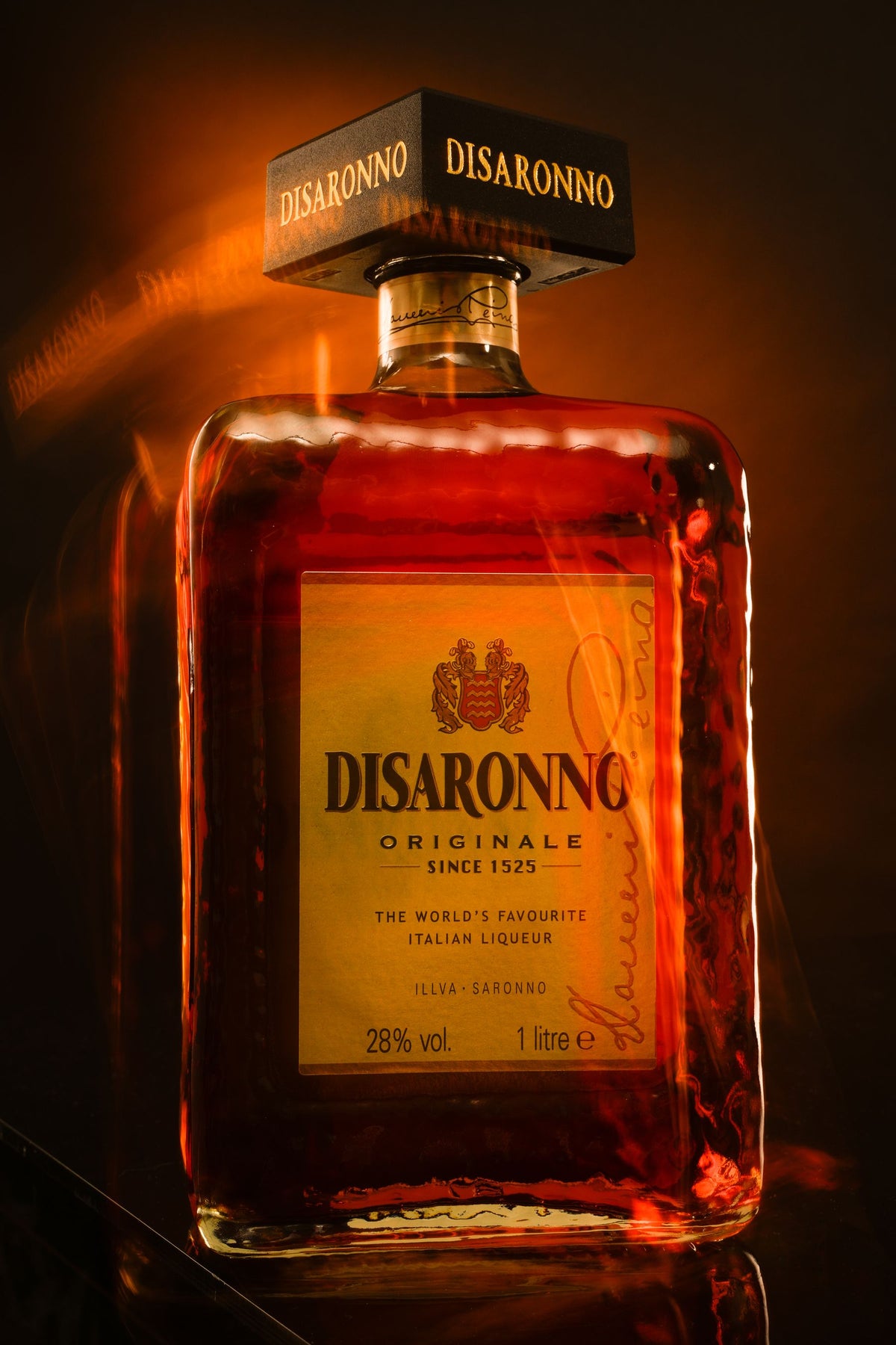 A bottle of Disaronno amaretto lit in warm amber tones
