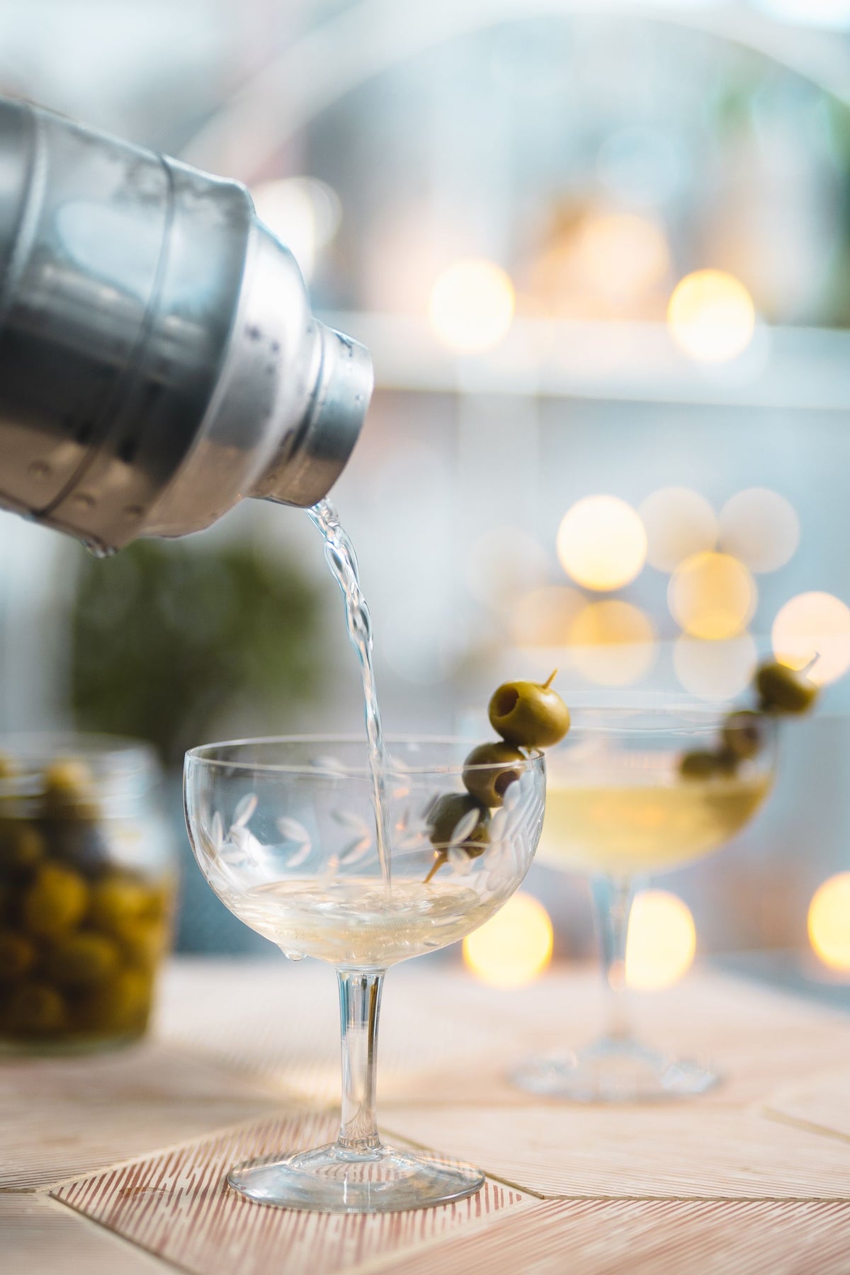 A vodka martini being poured at a bar counter