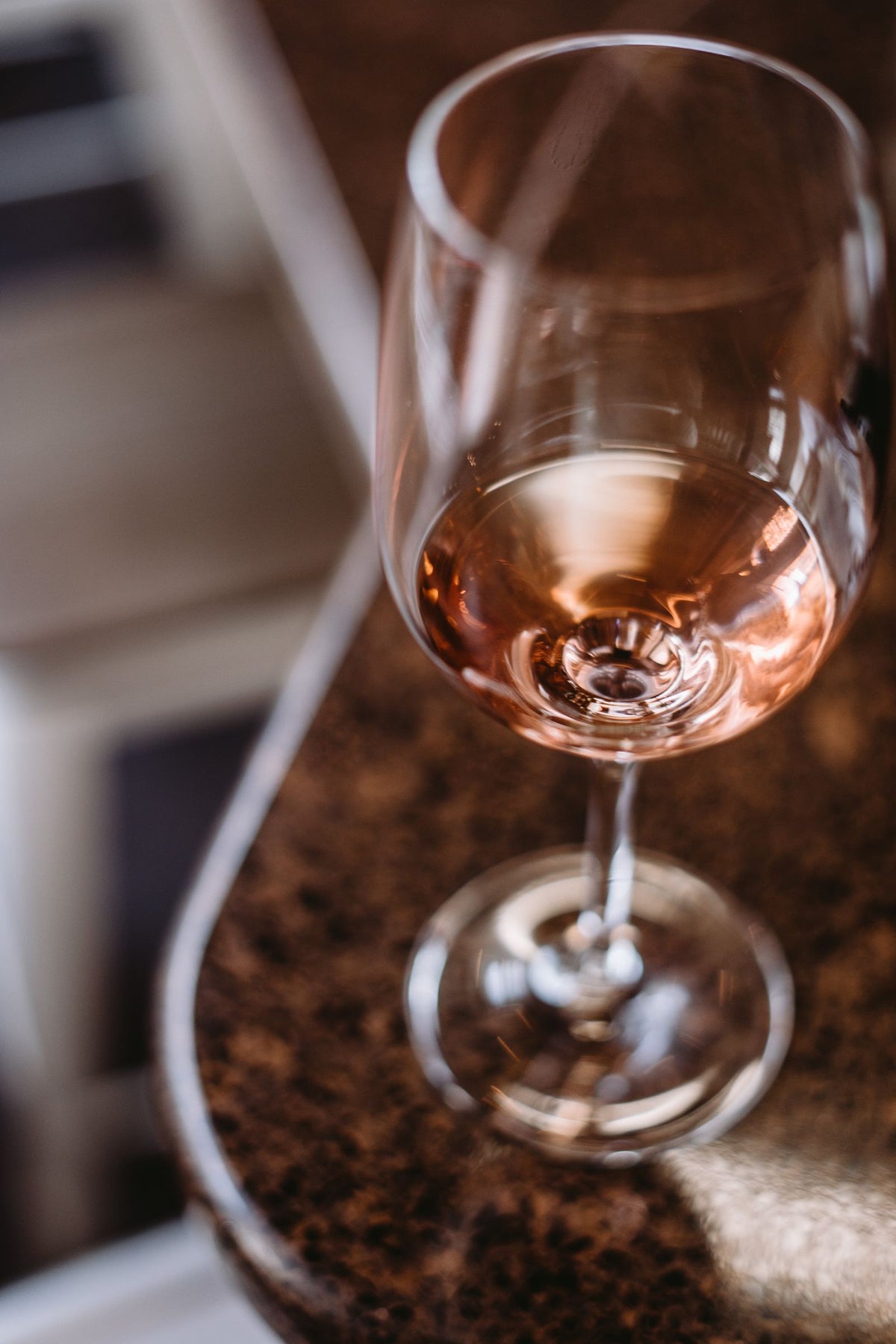 A glass of rose wine on a marble table at home