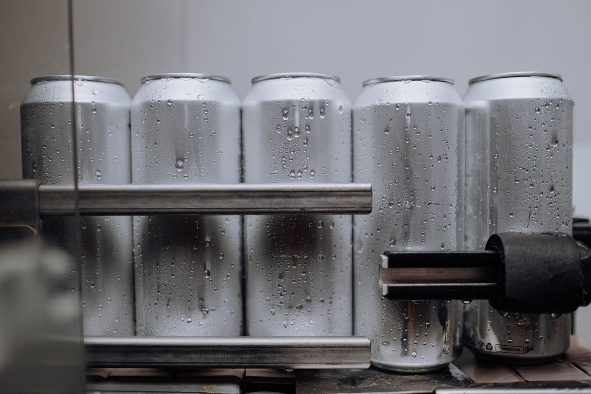 Chilled aluminium drink cans covered in condensation
