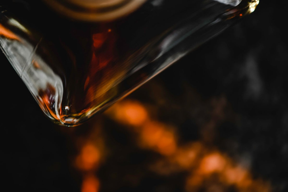 A whiskey bottle lit against a dark background