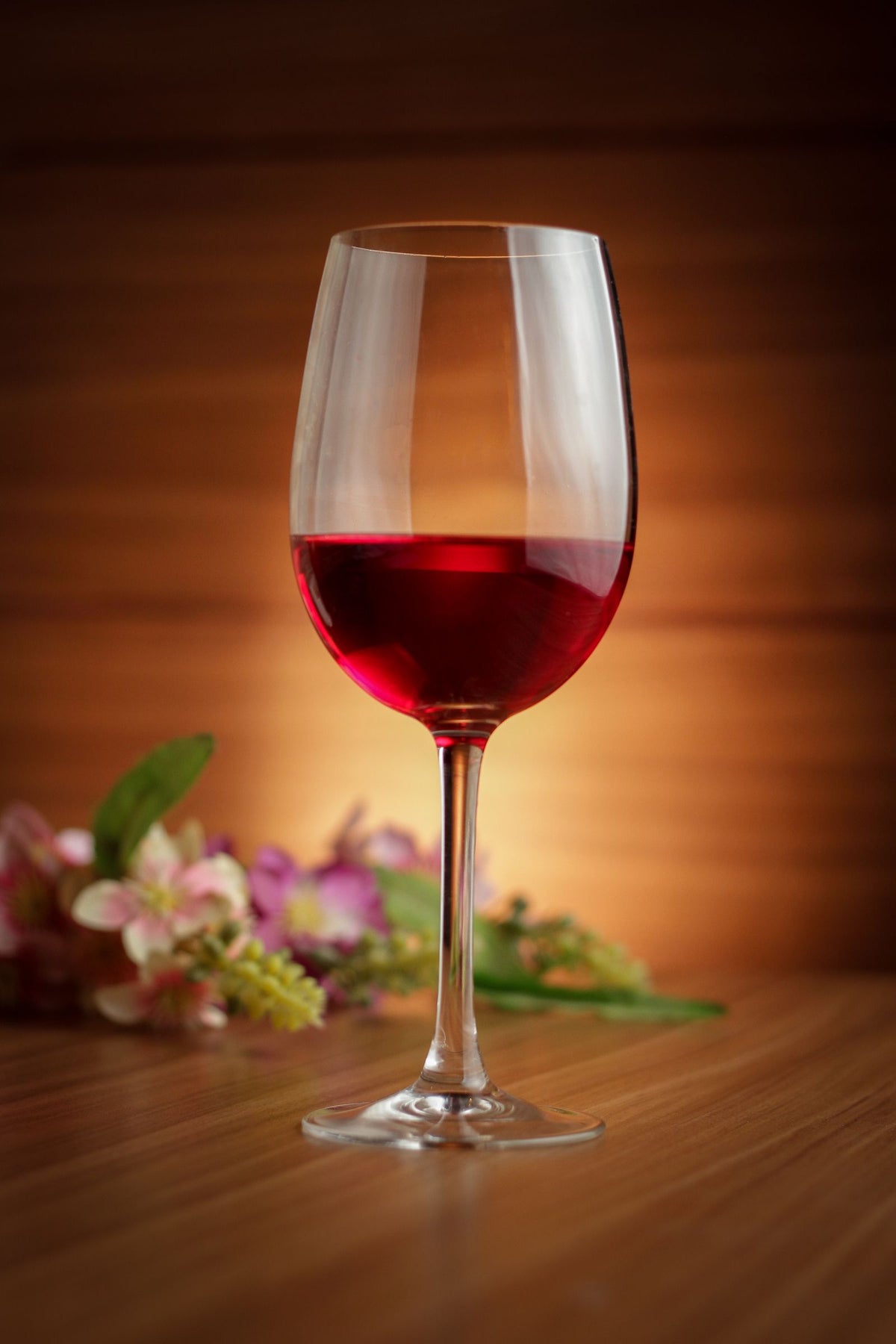 Glass of red wine on a wooden table