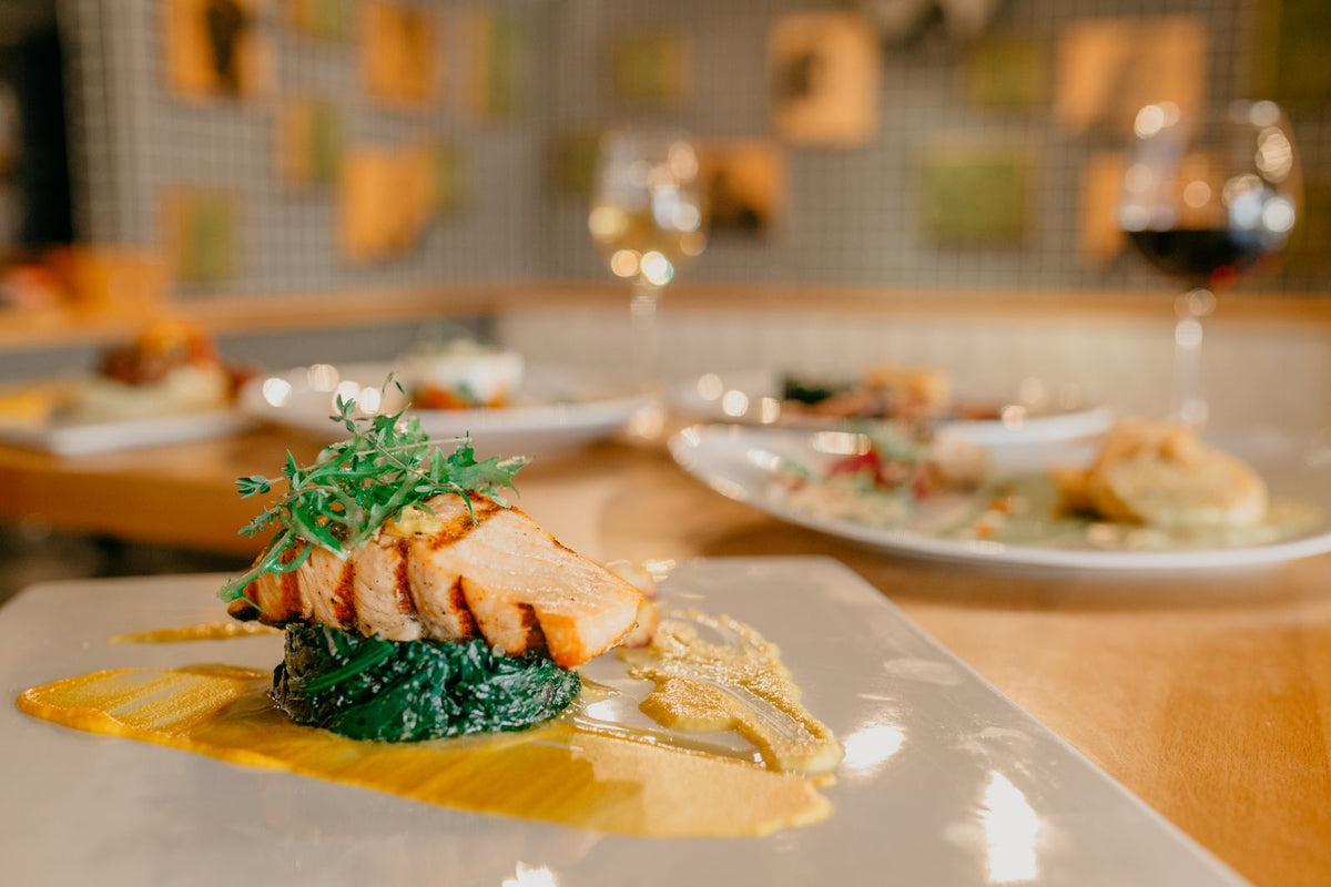 A salmon steak served on a plate with greens
